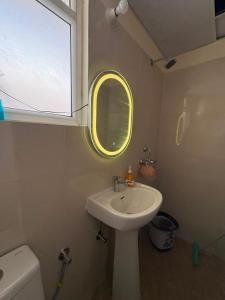 a small bathroom with a sink and a mirror at Bright & Modern 1BHK in Ghaziabad +13 photos