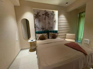a bedroom with a bed with two cats sitting on it at Bright & Modern 1BHK in Ghaziabad