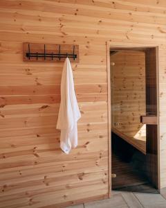 a sauna with a towel hanging on a wooden wall at Három Sziget Vendégház in Dunasziget
