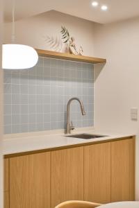 a kitchen with a sink and a shelf at Monday Mansion Hotel in Seoul +83 photos