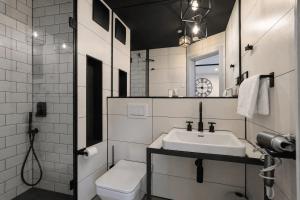 a white bathroom with a sink and a toilet at NOX HOTEL - Digital-Check-In & Virtual Reception - nahe Bretten & Karlsruhe in Wössingen