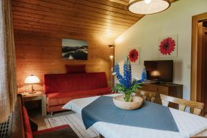 a living room with a table and a couch at Almblick Appartements in Sankt Jakob in Defereggen