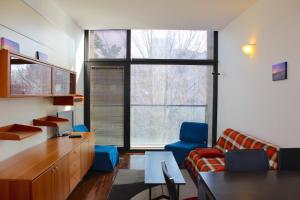 a living room with a couch and a chair and a table at Residenza Nervesa in Lignano Sabbiadoro