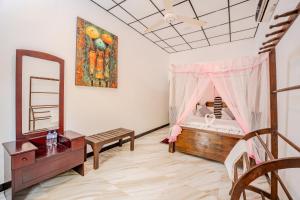 a room with a bed and a table and a mirror at Dudley Nature Resort in Habarana +78 photos