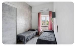a room with three beds and a window with red curtains at Camera dell' antico Arco Romano in Pozzuoli