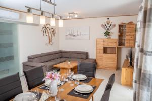 a dining room with a table and a couch at Beachfront Reiterer Villa V2 with Seaview 30 meters from the Beach - CROWONDER LUXURY RENT in Privlaka