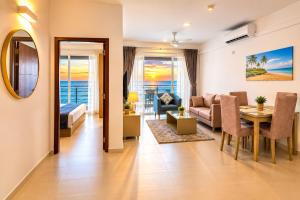 a living room with a couch and a dining room at Beachfront Sky Studio with Ocean View in Wattala