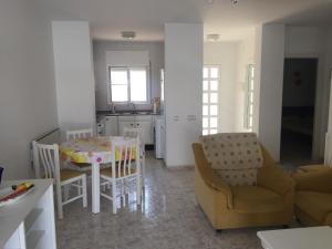 a kitchen and dining room with a table and chairs at Apartment Los Eucaliptus in L'Eucaliptus