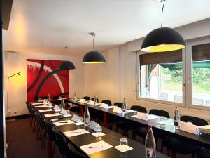a row of tables and chairs in a restaurant at Hôtel La Redoute in Les Rousses