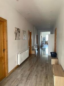 an empty room with wooden floors and a hallway with stairs at Cazare Turnisor in Sibiu