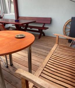 a wooden bench and a table in a room at Cazare Turnisor in Sibiu +4 photos
