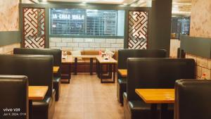 a dining room with tables and chairs in a restaurant at Hotel Paramveer in Muzaffarpur
