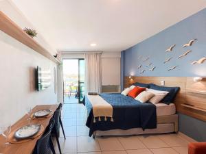 a bedroom with a bed with birds on the wall at Malia Beach - Muro Alto - Porto de Galinhas - Cozinha equipada in Porto De Galinhas +37 photos