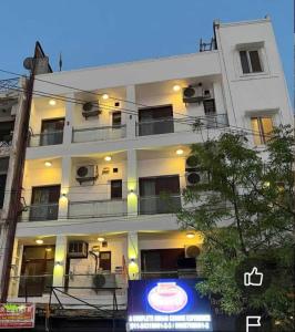 a white building with a sign in front of it at Hotel Bir Stay- Near Nizamuddin Dargah in New Delhi