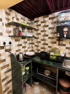 a kitchen with a counter with a stove at Jagdamba Bhawan in Kolkata