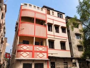 an orange and white building with a balcony at Jagdamba Bhawan in Kolkata