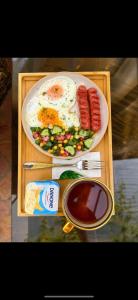 a tray with a plate of breakfast food with eggs and vegetables at Sole Family Guesthouse in Samarkand