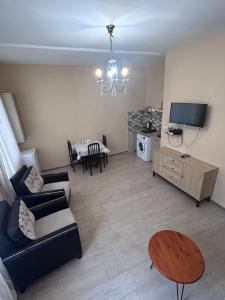 a living room with a couch and a table at Apartment near Tskaltubo spa resort in Tsqaltubo