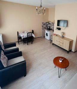 a living room with a couch and a table at Apartment near Tskaltubo spa resort in Tsqaltubo