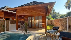 a villa with a pool and a house at The Tree Poolbar&Resort in Gili Islands