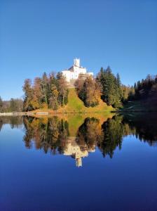a house on top of a hill next to a lake at Apartment Petra Zabok Horizon Suite in Zabok