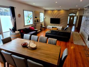 a living room with a table and a couch at Westend House Healesville in Healesville