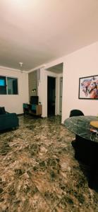 a living room with a couch and a table at Granja Vianna Charming in Cotia
