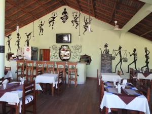 a restaurant with tables and chairs in a room at hotel trecicogne in Morondava
