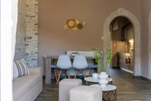 a living room with a couch and a table at Studios Diogenis in Porto Koufo