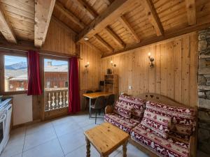 a living room with a couch and a table at Le Tyrol in La Plagne Tarentaise