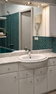 a bathroom with a white sink and a mirror at Seven Eleven Apartment HOTEL in Most City in Dnipro +33 photos