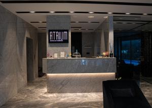 a lobby with a reception desk in a building at The V Hotel in Baghdād