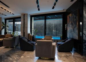a lobby with chairs and a view of a city at The V Hotel in Baghdād