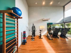a gym with treadmills and exercise equipment in a room at Malia Beach - Muro Alto - Porto de Galinhas - Cozinha equipada in Porto De Galinhas