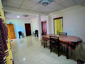 a dining room with a table and chairs at River Park Holiday Home in Badulla