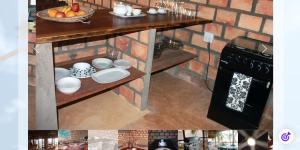 a kitchen with a table with bowls and plates on it at Mahale Resort - Casa 1 in Jangamo