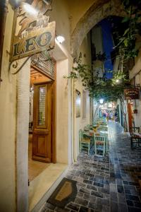 a restaurant with a table and chairs on a street at Leo Hotel in Rethymno