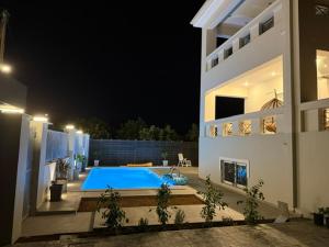 a house with a swimming pool at night at Exclusive Villa with Pool in Káto Ássos