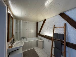 a bathroom with a sink and a bath tub at Ferienwohnung Silvia in Roßhaupten +20 photos