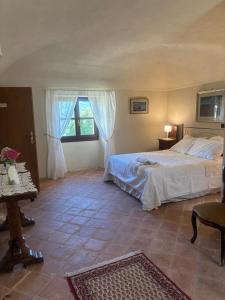 a bedroom with a large bed and a window at Guest House Villa Castello in Nucetto