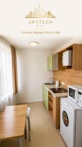 a kitchen with a table and a counter top at Seven Eleven Apartment HOTEL in Most City in Dnipro