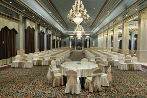a banquet hall with tables and chairs and a chandelier at Rajwada Hotel and Resort in Bareilly
