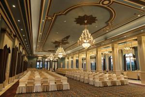 a large banquet hall with white tables and chandeliers at Rajwada Hotel and Resort in Bareilly +60 photos