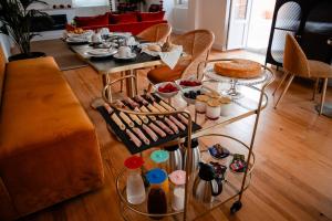 a living room with a table with food on it at Chalet Santo António in Sintra