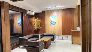 a waiting room with a couch and a table at HOTEL MAJESTIC in Palembang