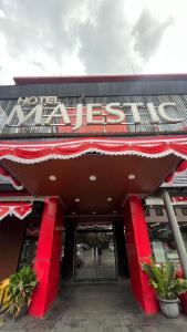 a building with a sign on the front of it at HOTEL MAJESTIC in Palembang