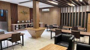 a dining room with wooden tables and chairs at HOTEL MAJESTIC in Palembang