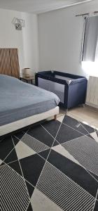 a bedroom with a bed and a black and white floor at La Source in Villers-le-Lac