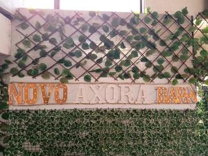 a sign that says move avalonia on a wall with plants at Novo Axora Lounge & Accommodation Kimbo Ruiru Kimbo Lopha Stage in Ruiru