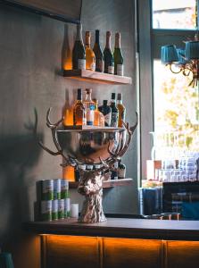 a shelf with bottles of alcohol on top of a counter at The Goat in Boots in London +12 photos